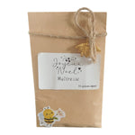 Cadeau de Noël pour maîtresse avec sachet de graines personnalisé, étiquette Joyeux Noël Maîtresse et breloque abeille dorée.