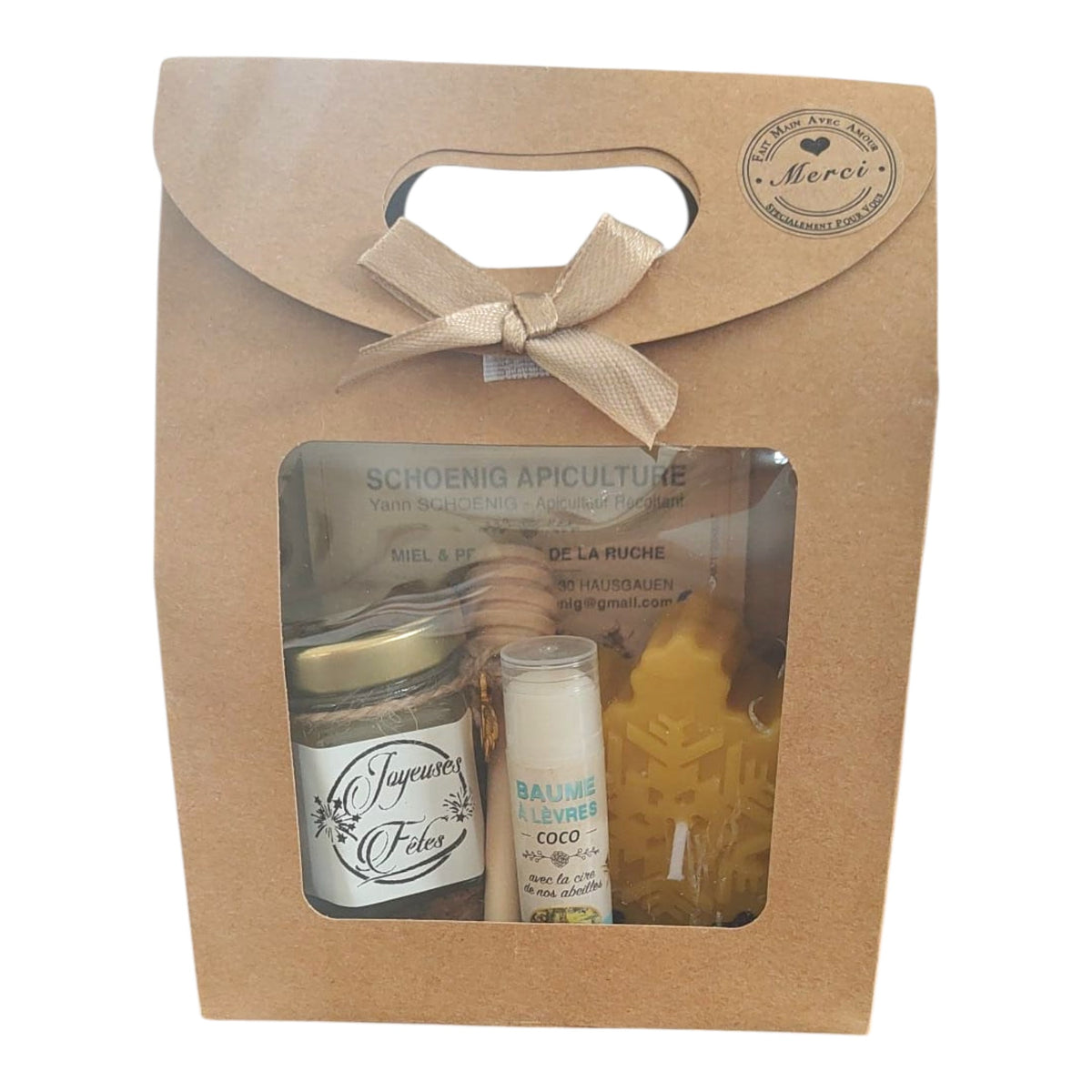 Coffret cadeau Joyeuses Fêtes comprenant un mini pot de miel personnalisé, un baume à lèvres coco artisanal, une bougie flocon en cire d'abeille et une boîte kraft.