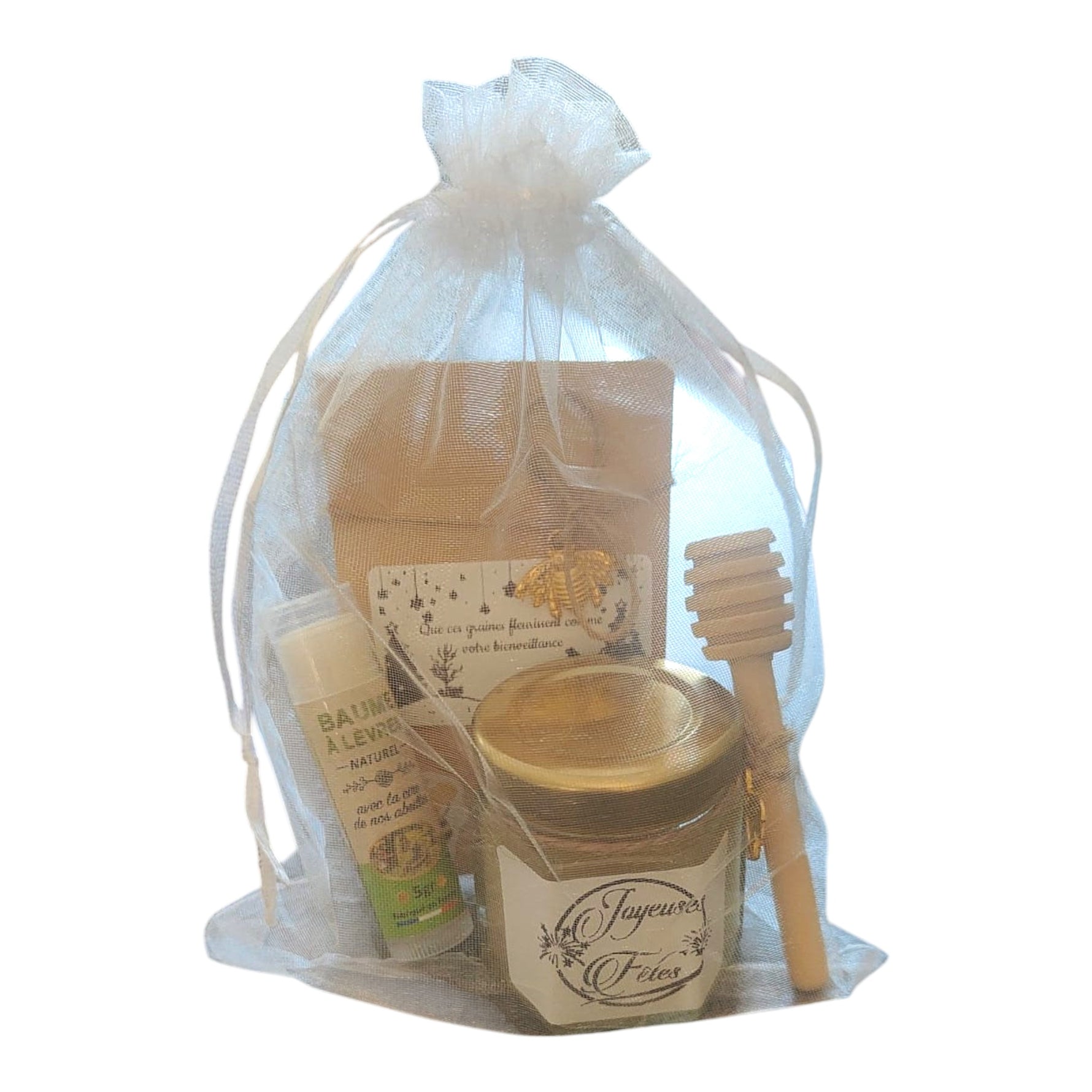 Coffret cadeau de Noël personnalisé comprenant un mini pot de miel artisanal avec étiquette personnalisée, un baume à lèvres à la cire de nos abeilles, un sachet de graines personnalisé et une cuillère à miel en bois.