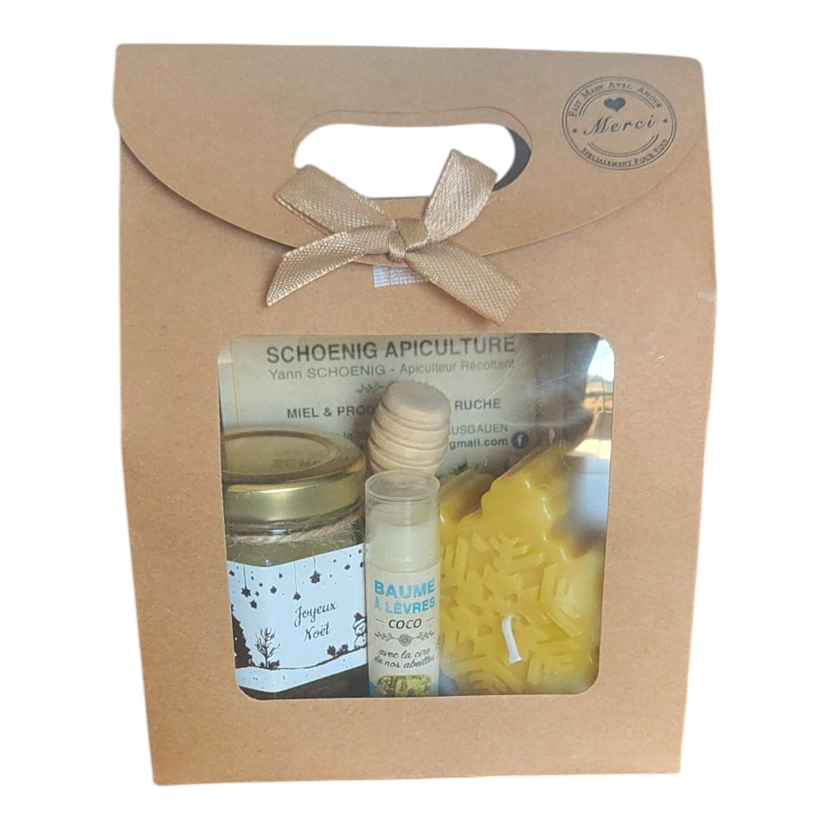 Coffret cadeau Noël avec miel, baume framboise, bougie flocon de Noël et étiquette Joyeux Noël.