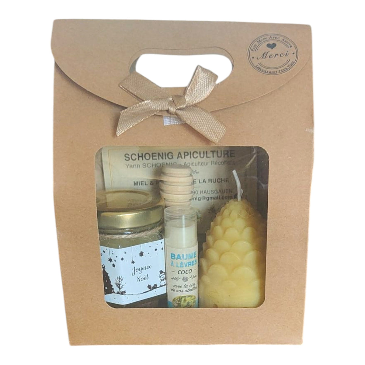 Coffret cadeau Noël avec miel, baume naturel, bougie pomme de pin et étiquette Joyeux Noël.