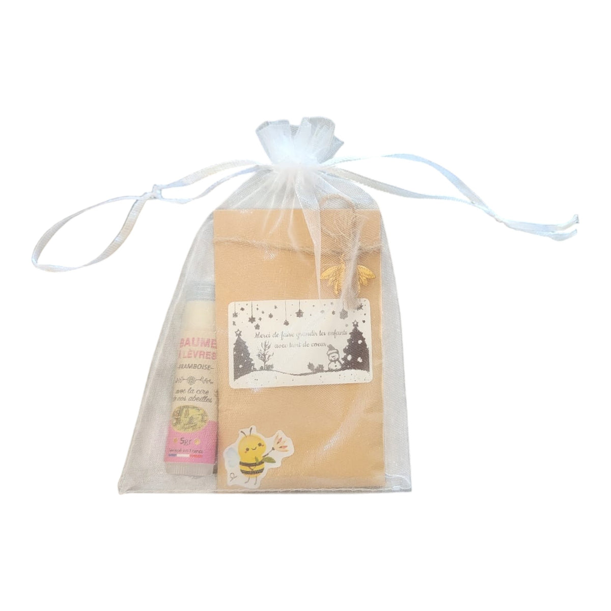 Idée cadeau de Noël personnalisée comprenant un sachet de graines avec étiquette Joyeux Noël et un baume à lèvres artisanal à la cire d'abeille.